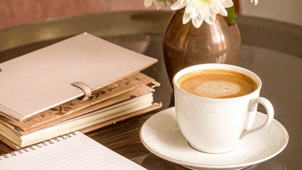 Cup of coffee with planner ready to create a simple weekly meal routine for solo living