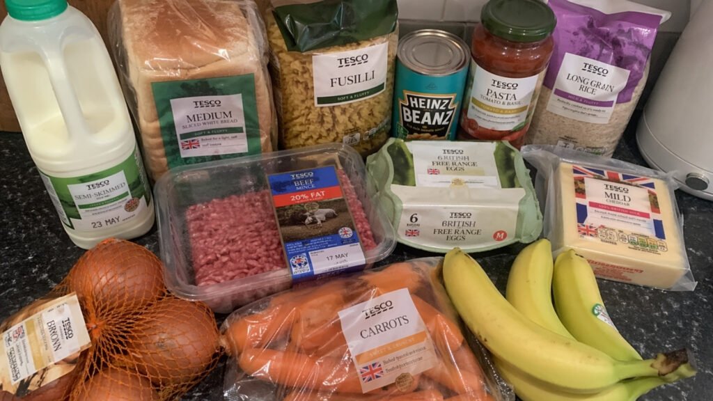 £20 grocery haul laid out on kitchen counter, simple realistic UK ingredients